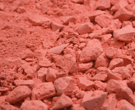 Colored grainy crushed chalk's textured background. Red.