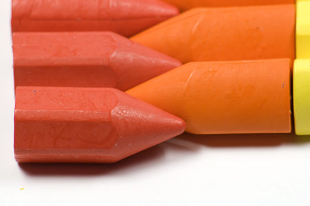 Stacked in rows wax crayons, red,orange and yellow