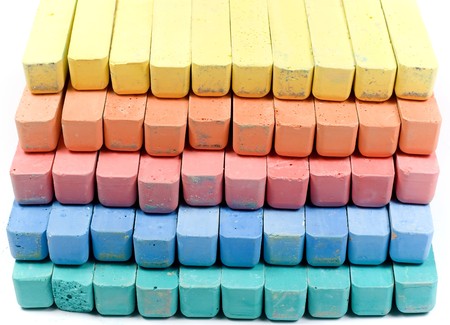 Five colors childrens chalk, stacked in rowsの写真素材