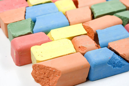Set of mixed colored crushed childrens chalks, stacked in horizontal rowsの写真素材