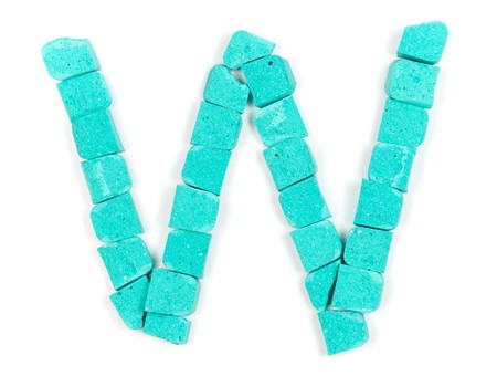 Letter W from cyan stones on whiteの写真素材