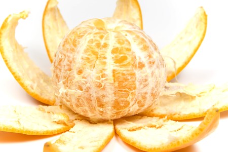 Orange with peel in view flower, on whiteの写真素材