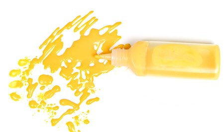 Dark yellow blot with the empty plastic open tubeの写真素材