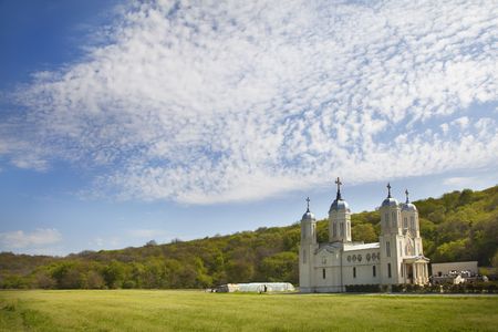 monastery in plain in front of a forestの写真素材