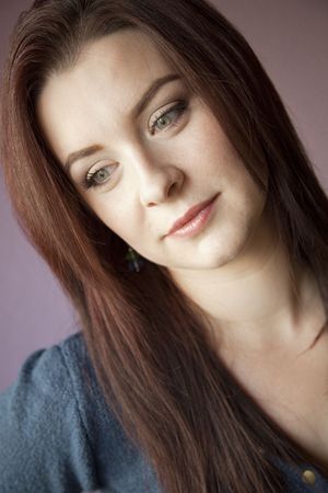 beautiful woman portrait isolated on mauve backgroundの写真素材