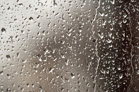 rain, drops on the glass that forms an abstract backgroundの写真素材