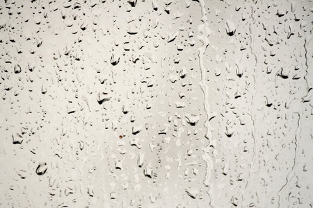 rain, drops on the glass that forms an abstract backgroundの写真素材
