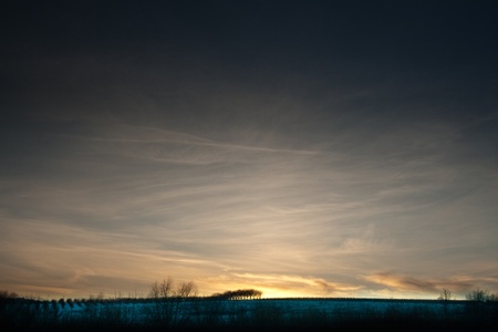 sunset sky crossed by planeの写真素材