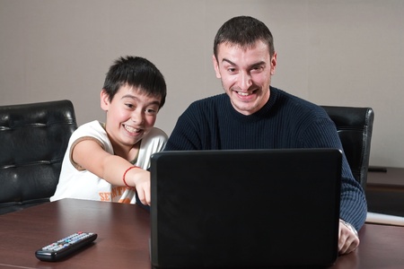portrait of two young men in front of computerの写真素材
