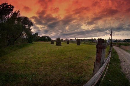 majestic sunset clouds and path through a mountain meadow to horizonの写真素材