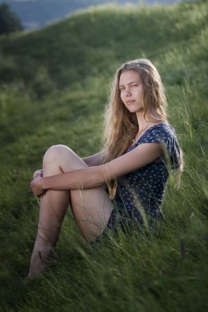 beautiful young woman relaxing in the grassの写真素材