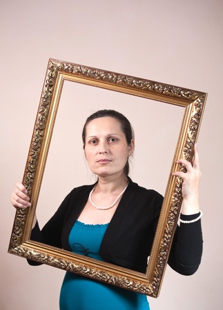 beautiful woman framed in a antique frameの写真素材