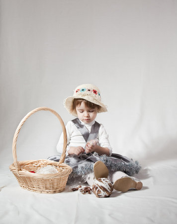 Young girl with a wicker basket on white background