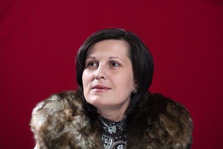 portrait of a beautiful woman on red backgroundの写真素材