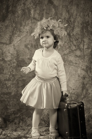 Lonely girl with suitcaseの写真素材