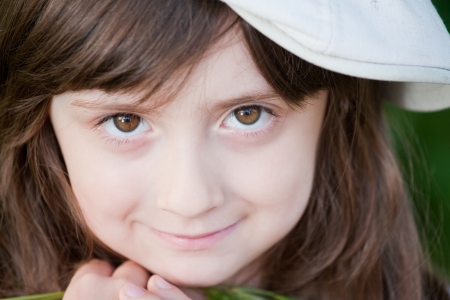 Adorable little girl smiling outdoorsの写真素材