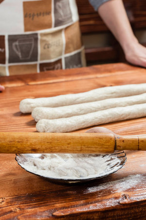 Chef preparing dough in a kitchenの写真素材