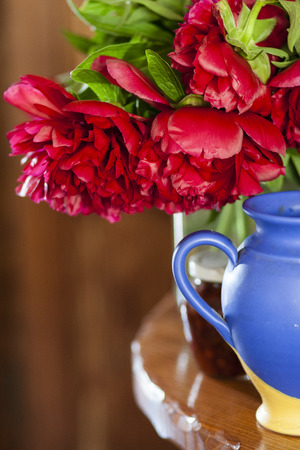 Pink peonies in vase on wood backgroundの写真素材