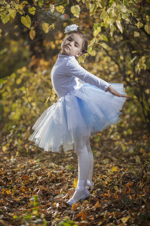 Little ballerina in autumn parkの写真素材
