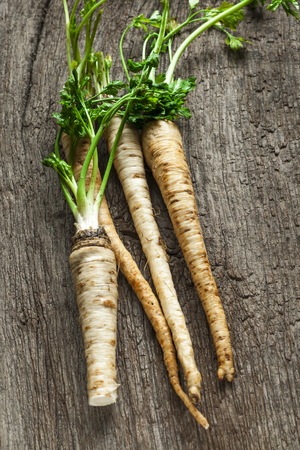 parsley root on old wooden tableの写真素材