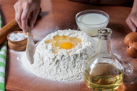 Baker prepared flour for baking on kitchen tableの写真素材