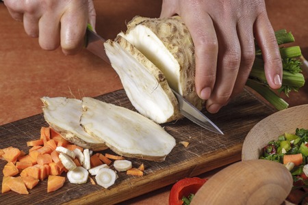 Chef chopping  vegetables on kitchen boardの写真素材