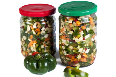 chopped vegetables in jars on white isolateの写真素材