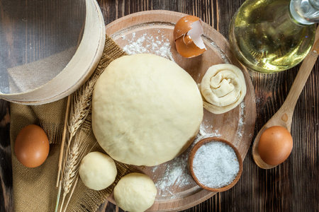 composition with dough and ingredients on wooden table
