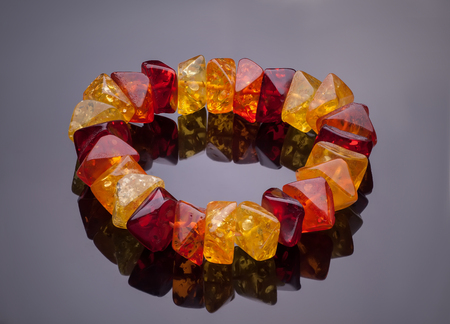 bracelet of colored stones isolated on a gray backgroundの写真素材