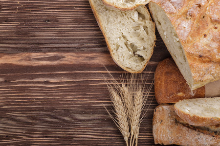 Fresh homemade bread placed on a wooden tableの写真素材