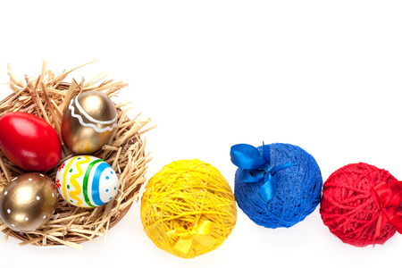 Colorful painted easter eggs in  basket on a whit backgroundの写真素材