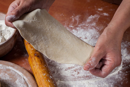 Baker prepared dough for baking delicious on  kitchen table