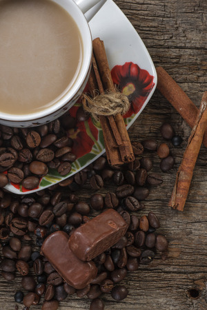 cup of coffee and coffee beans on old wooden tableの写真素材