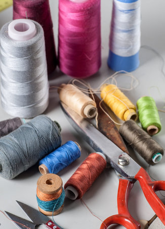 still life of spools of thread on a wooden background