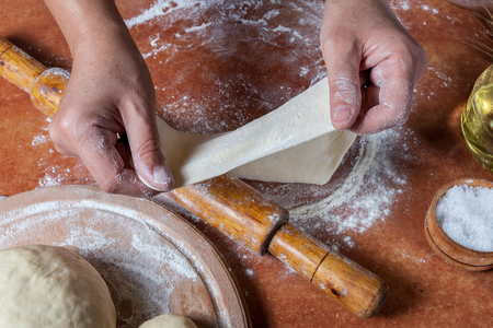 Baker prepared dough for baking delicious on  kitchen tableの写真素材