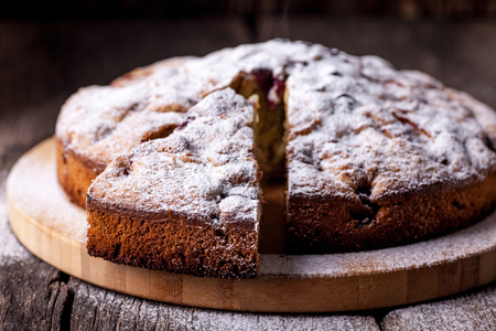 apple pie and cherry on a old rustic wooden tableの写真素材