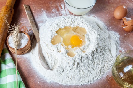 Baker prepared flour for baking on kitchen tableの写真素材