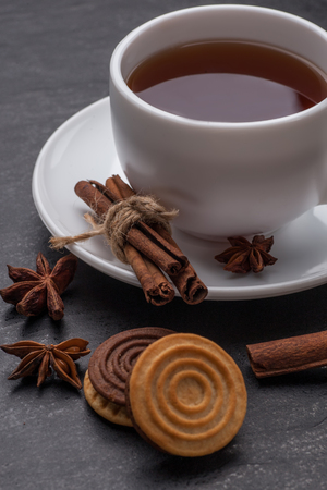 white tea cup and cinnamon on a graphite tableの写真素材