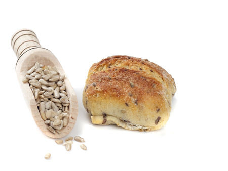 bread and sunflower kernels isolated on white backgroundの写真素材