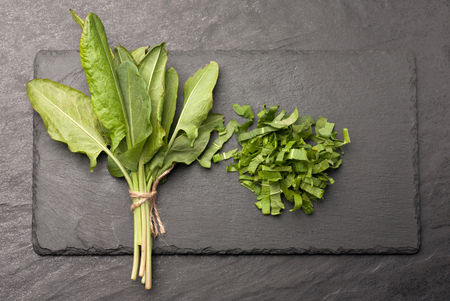 Fresh sorrel on a black stone graphit table. Food vegetableの写真素材