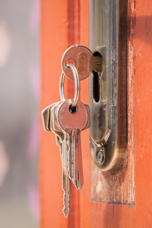 Key in keyhole on door. Rusty keys in old door lock. Selective focusingの写真素材