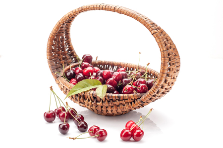 Cherries  in basket isolated on white backgroundの写真素材