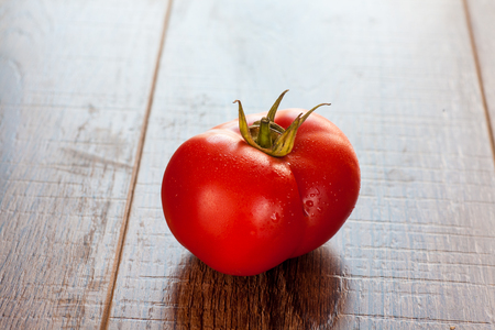 tomato on wooden table, vegetarian natural foodの写真素材