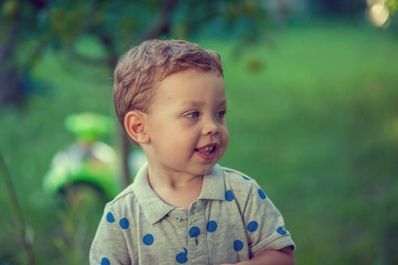 Portrait of a happy little boy in the parkの写真素材