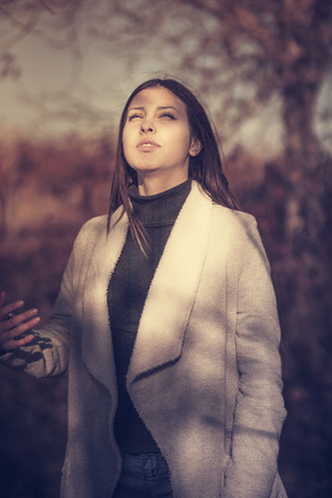 Portrait of a beautiful girl in the  autumn parkの写真素材