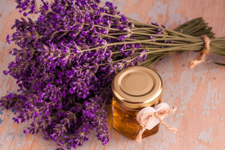 Lavander with aromatic oil on old wooden backgroundの写真素材