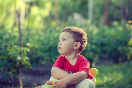 Portrait of a happy little boy in the parkの写真素材