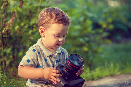 Little boy with camera in the parkの写真素材
