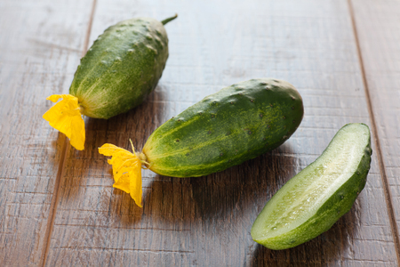 Fresh cucumbers on wooden table. Vegetarian food.の写真素材