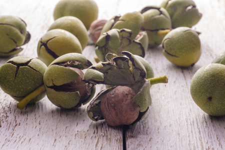 Green nuts that peeled on wooden table